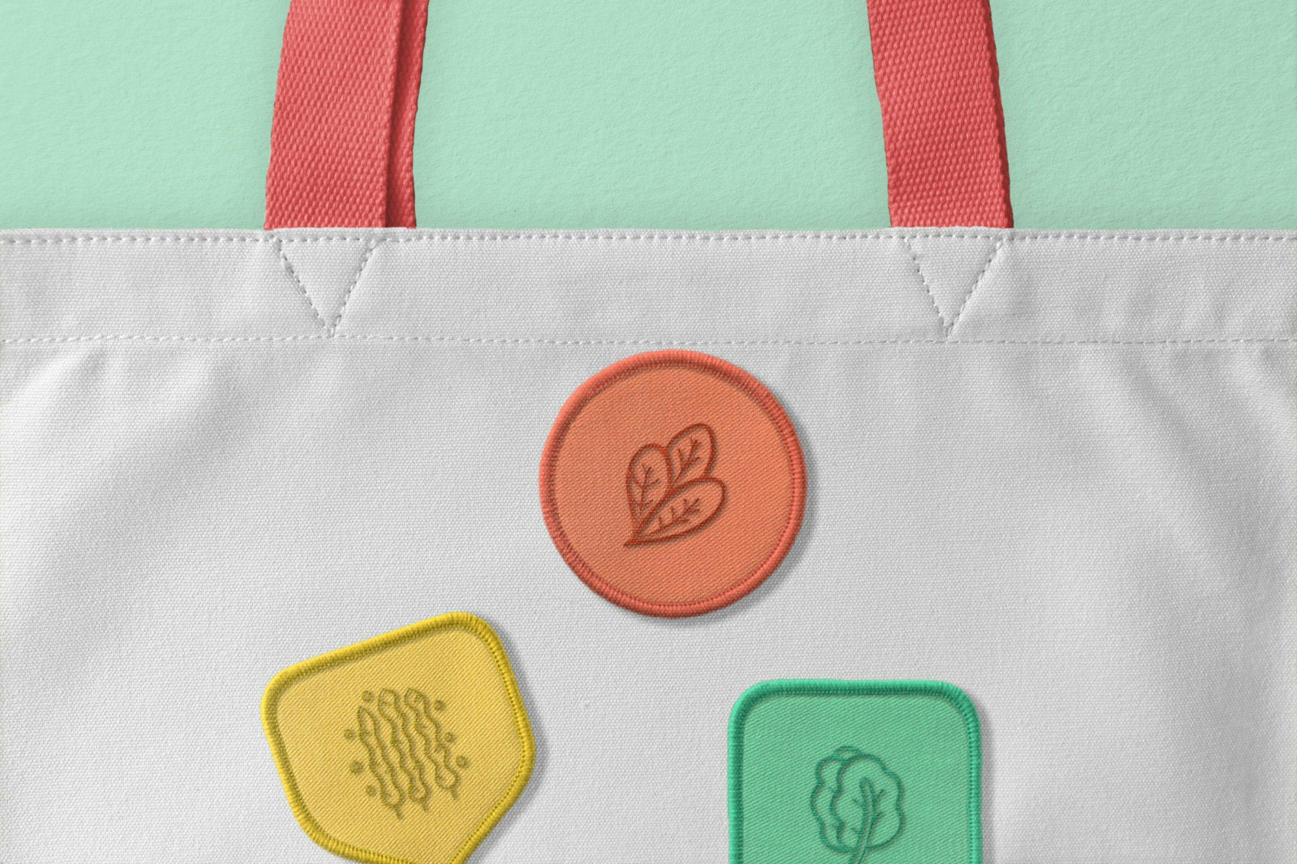 Kafka's Organic's shopping bag decorated with badges